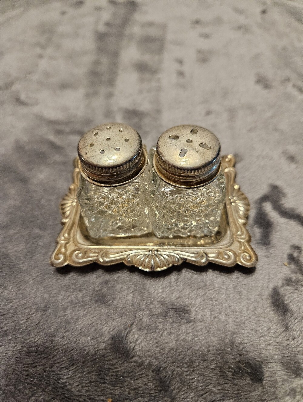 Vintage mini crystal glass salt and pepper shakers with a diamond pattern.